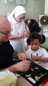 Peter introduces hearing aids to two new pupils at Gualandi Deaf School